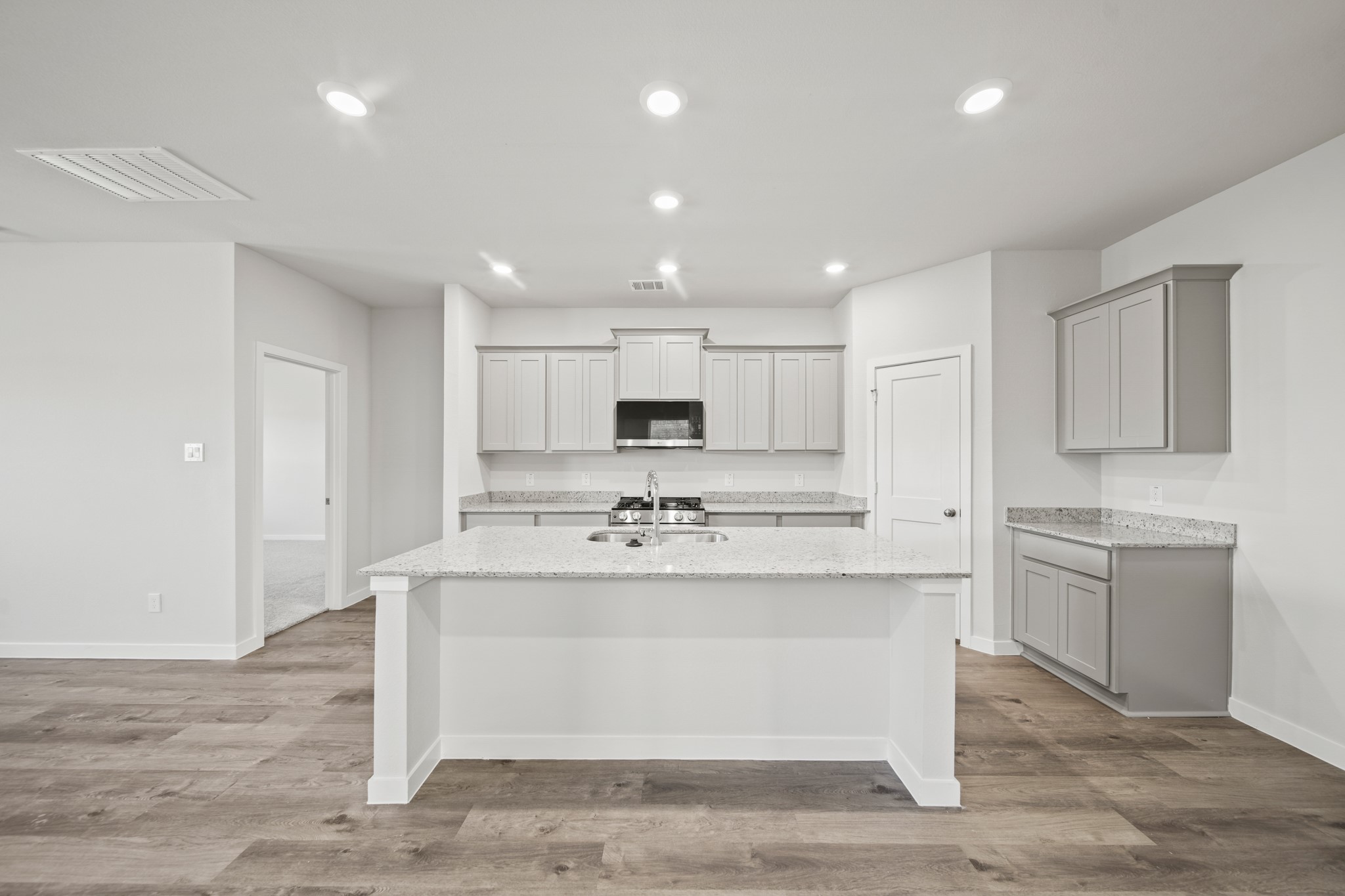 314 Bennett Street Angleton, TX 77515 - Photo 4 of 27 a kitchen with kitchen island sink stove and white cabinets