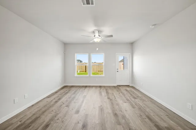 wooden floor in an empty room with a window