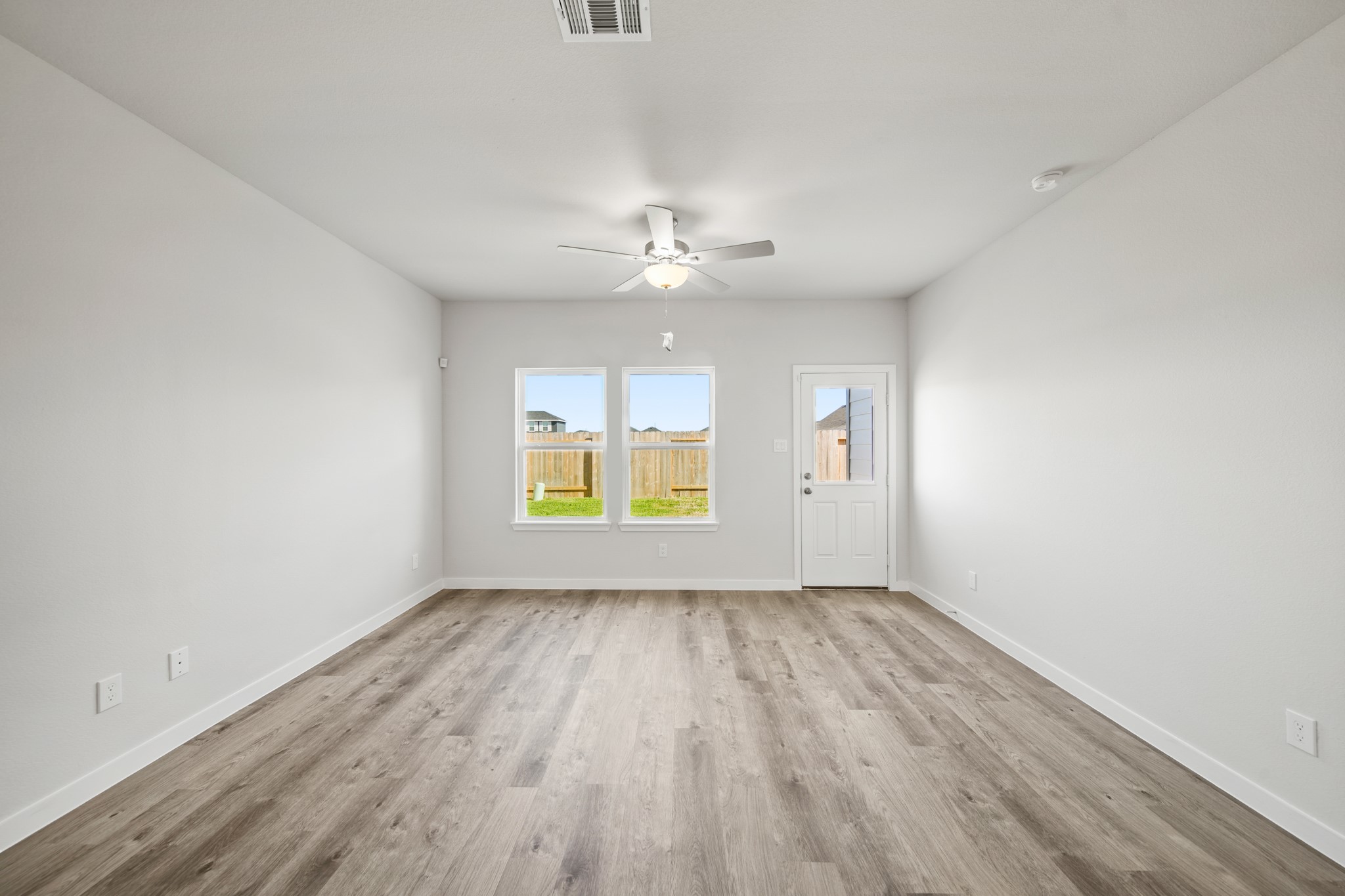 314 Bennett Street Angleton, TX 77515 - Photo 8 of 27 wooden floor in an empty room with a window