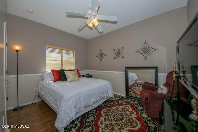 3701 East Northern Dancer Road Tucson, AZ 85739 - Photo 18 of 32 a bedroom with a bed and a chandelier
