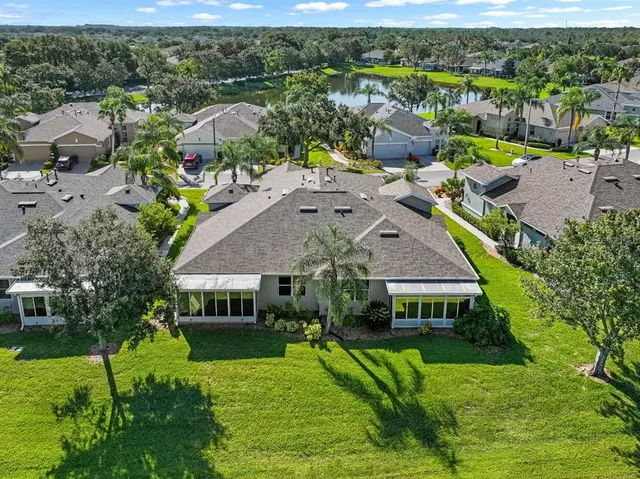 a view of a house with a yard and potted plants