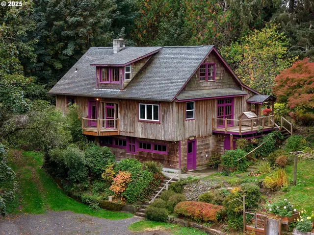 an aerial view of a house with swimming pool next to a yard