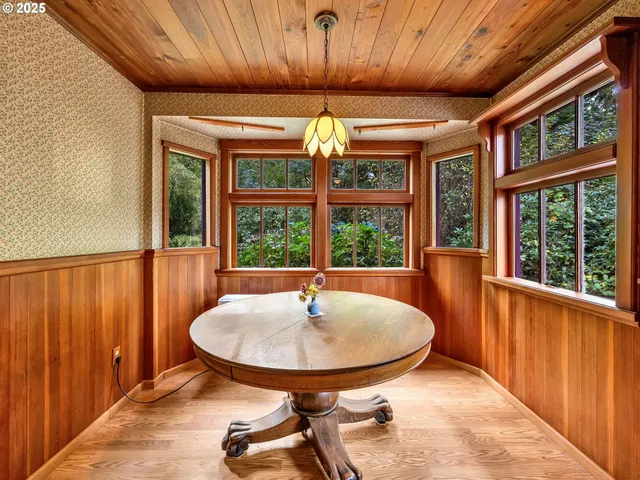 a dining room with furniture window and outside view