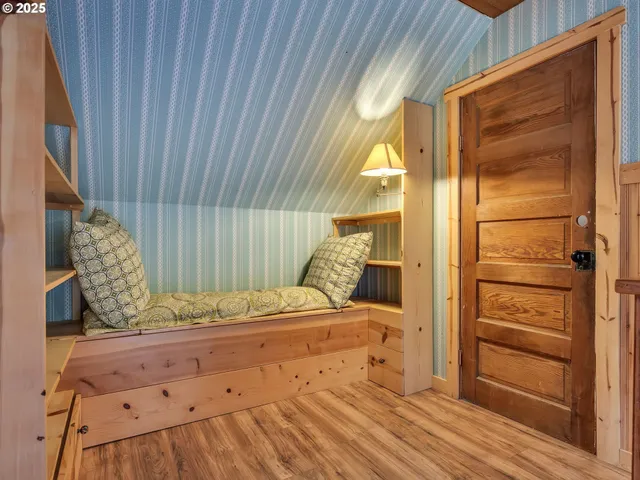 a living room with a bed and a window