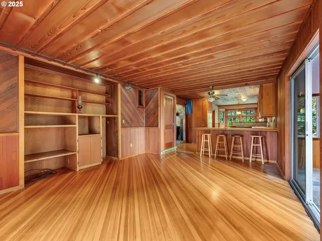 a view of a patio with wooden floor and iron fence