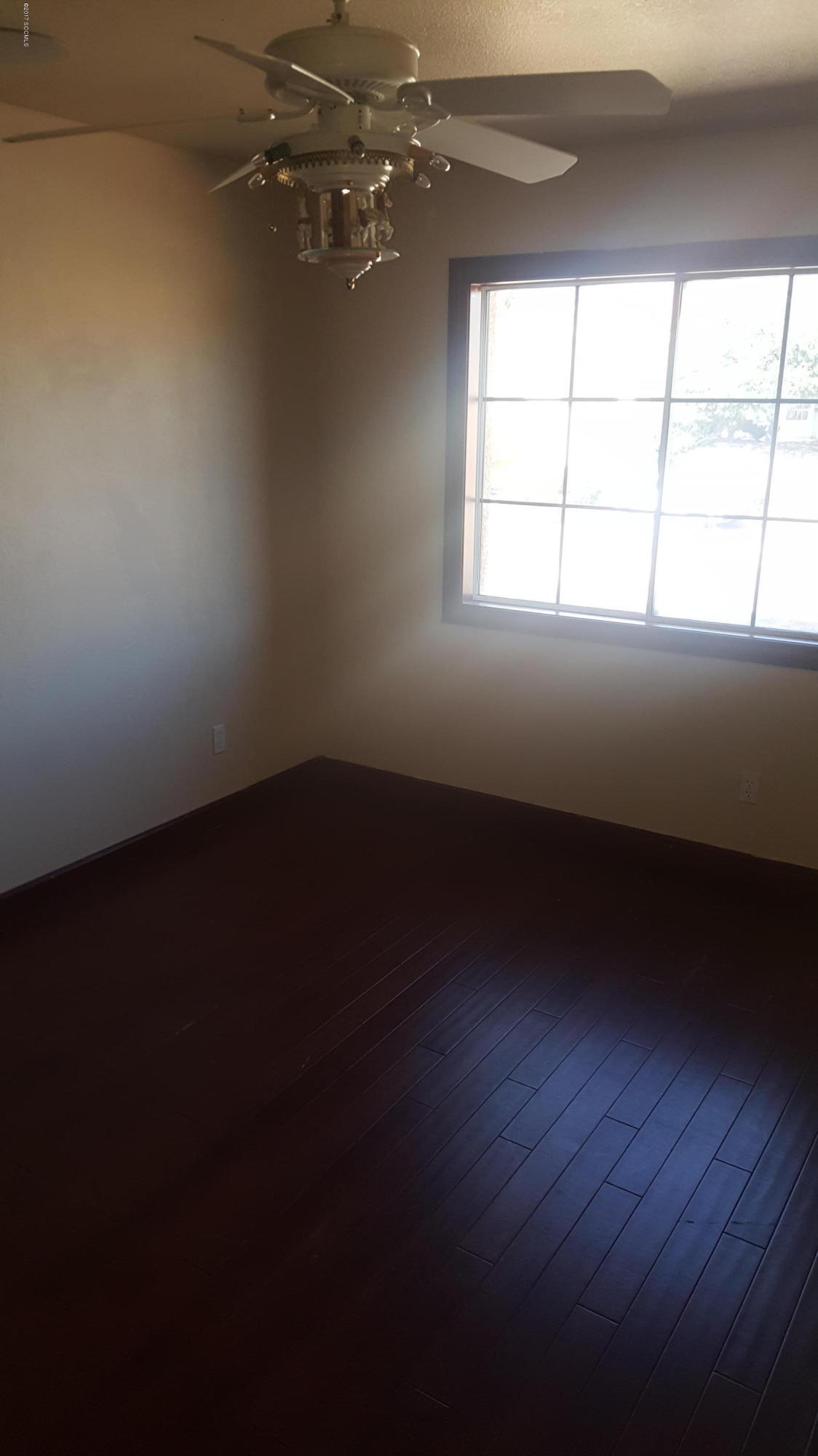 75 Highland Circle Rio Rico, AZ 85648 - Photo 15 of 19 wooden floor in an empty room with a window