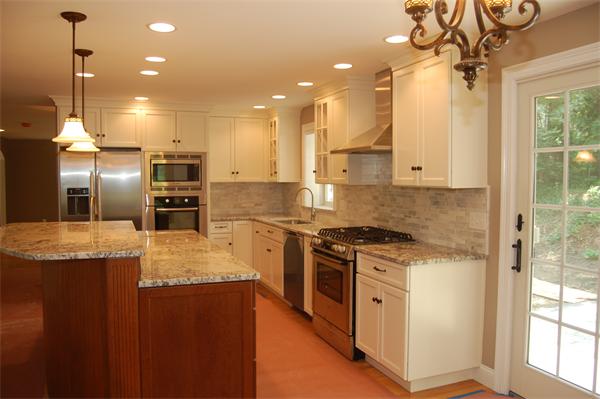17 Willowdale Road Winchester, MA 01890 - Photo 12 of 24 a kitchen with stainless steel appliances granite countertop a sink a stove and a refrigerator