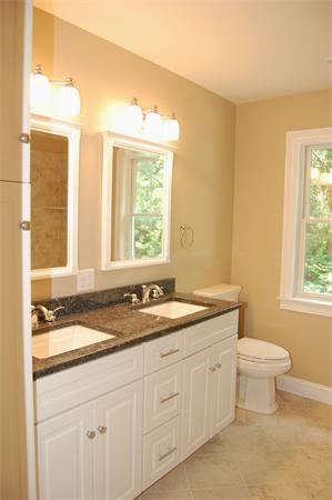 17 Willowdale Road Winchester, MA 01890 - Photo 16 of 24 a bathroom with a granite countertop sink a toilet and a window