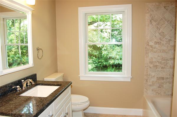 17 Willowdale Road Winchester, MA 01890 - Photo 17 of 24 a bathroom with a granite countertop sink toilet and mirror