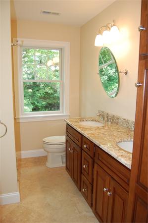 17 Willowdale Road Winchester, MA 01890 - Photo 19 of 24 a bathroom with a granite countertop toilet a sink and a window