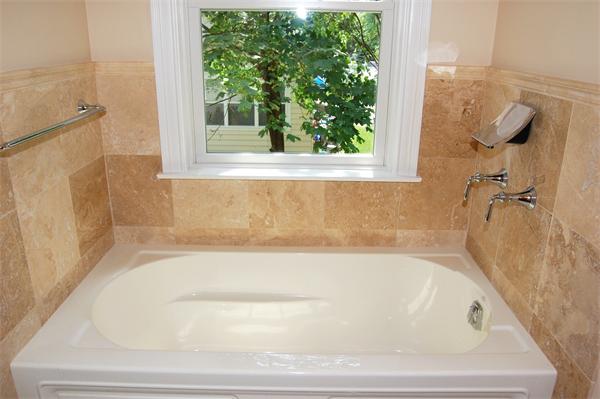 17 Willowdale Road Winchester, MA 01890 - Photo 20 of 24 a white bath tub sitting next to a window