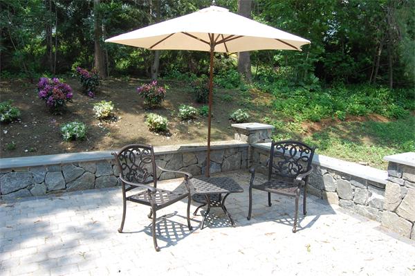 17 Willowdale Road Winchester, MA 01890 - Photo 22 of 24 a patio with tables and chairs and a umbrella