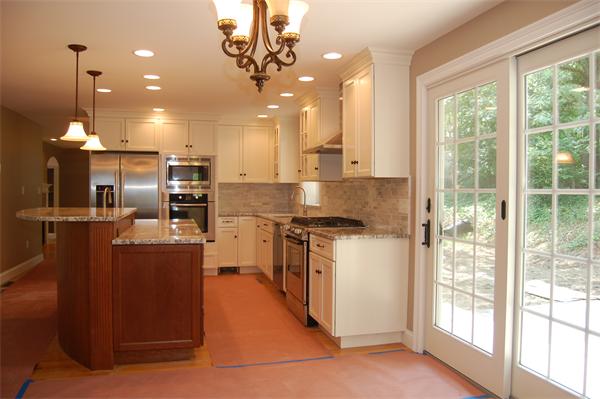 17 Willowdale Road Winchester, MA 01890 - Photo 9 of 24 a kitchen with stainless steel appliances granite countertop a stove a sink and a refrigerator