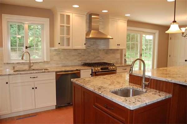 17 Willowdale Road Winchester, MA 01890 - Photo 10 of 24 a kitchen with kitchen island granite countertop a sink a counter space appliances and cabinets