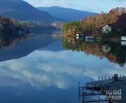 a view of residential houses with outdoor space and lake view