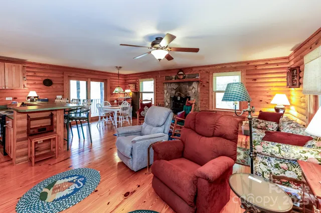 a living room with furniture a wooden floor and a chandelier