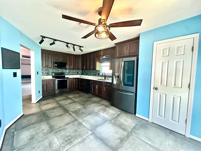 a kitchen with a sink stove and cabinets