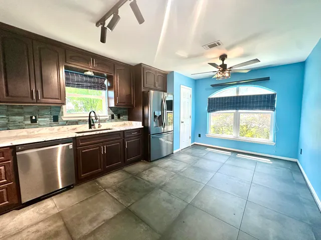 a view of a kitchen with a sink and cabinets