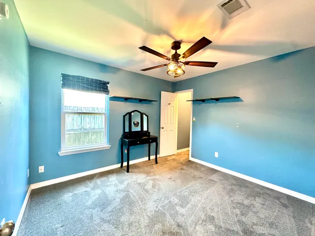a view of a room with a window and chandelier