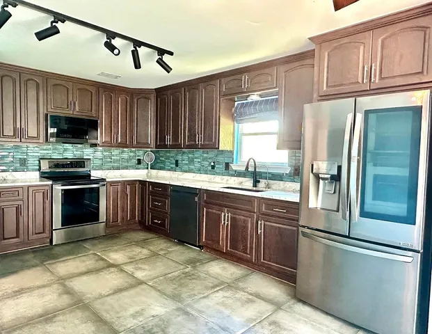 a kitchen with a sink and a refrigerator