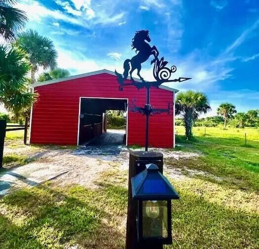 1303 Cabbage Lane Okeechobee, FL 34974 - Photo 2 of 14 a front view of a house with a yard
