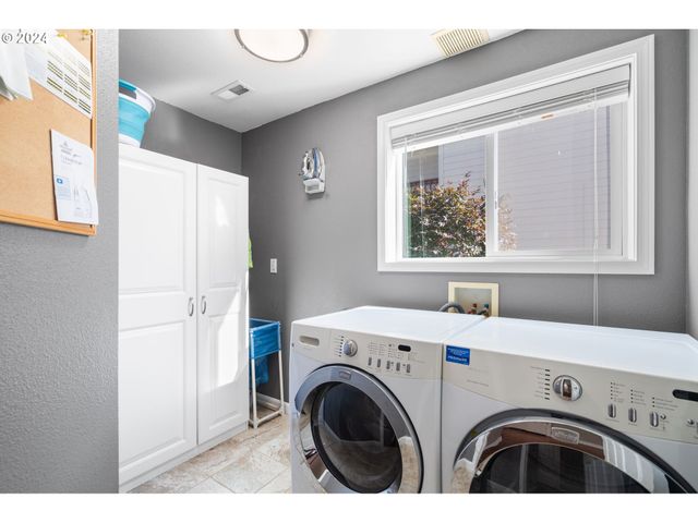 a kitchen that has a lot of cabinets and wooden floor