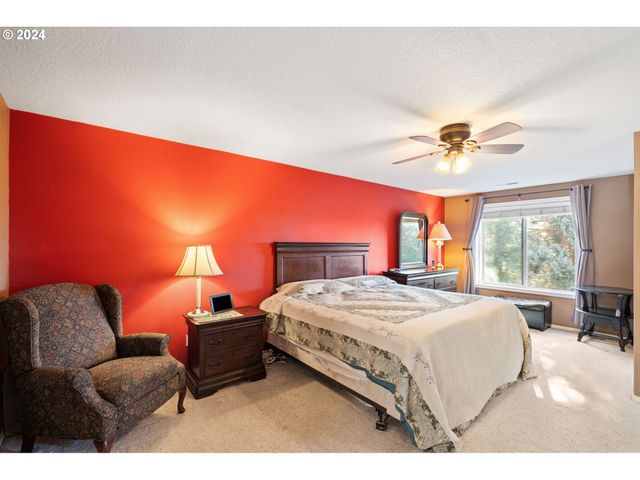 a large bedroom with a large bed and a chandelier