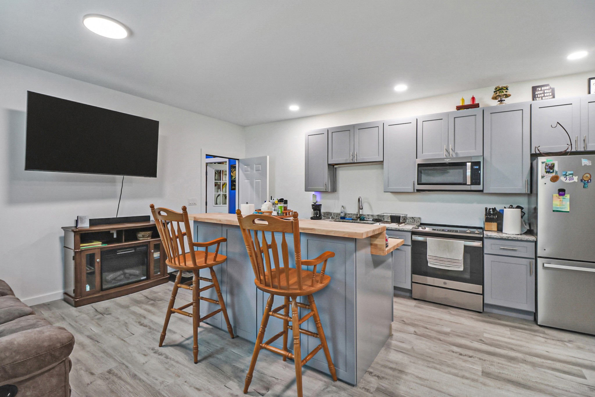 148 Porter Lane Spring City, TN 37381 - Photo 12 of 53 a kitchen with stainless steel appliances granite countertop a stove top oven a sink a refrigerator with a dining table and chairs with wooden floor