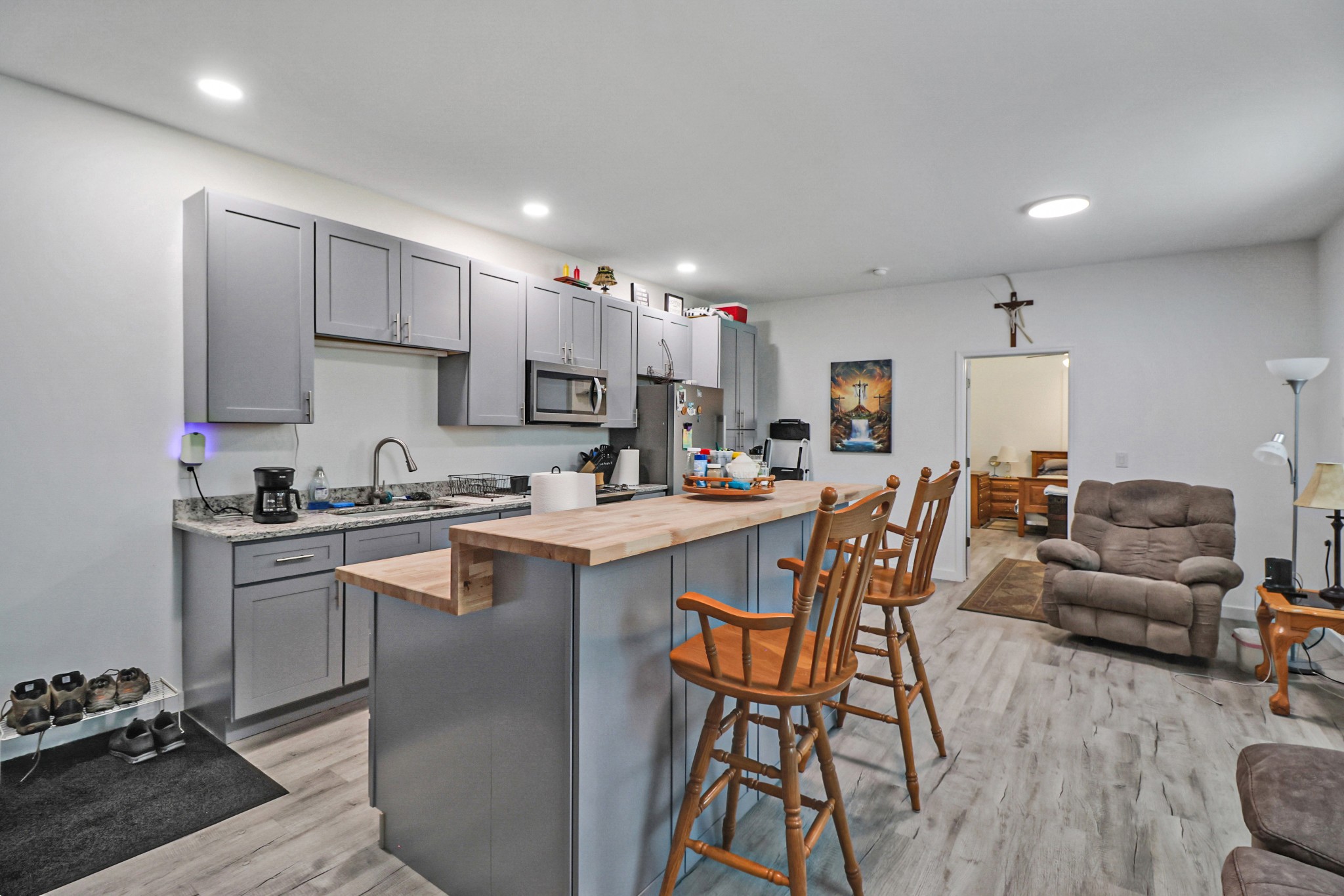 148 Porter Lane Spring City, TN 37381 - Photo 13 of 53 a kitchen with stainless steel appliances granite countertop a stove top oven a sink dishwasher a dining table and chairs with wooden floor