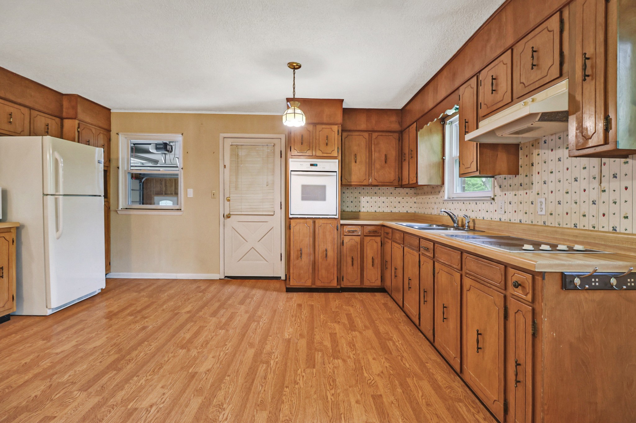 148 Porter Lane Spring City, TN 37381 - Photo 31 of 53 a kitchen with stainless steel appliances granite countertop a refrigerator a stove a sink dishwasher and white cabinets with wooden floor