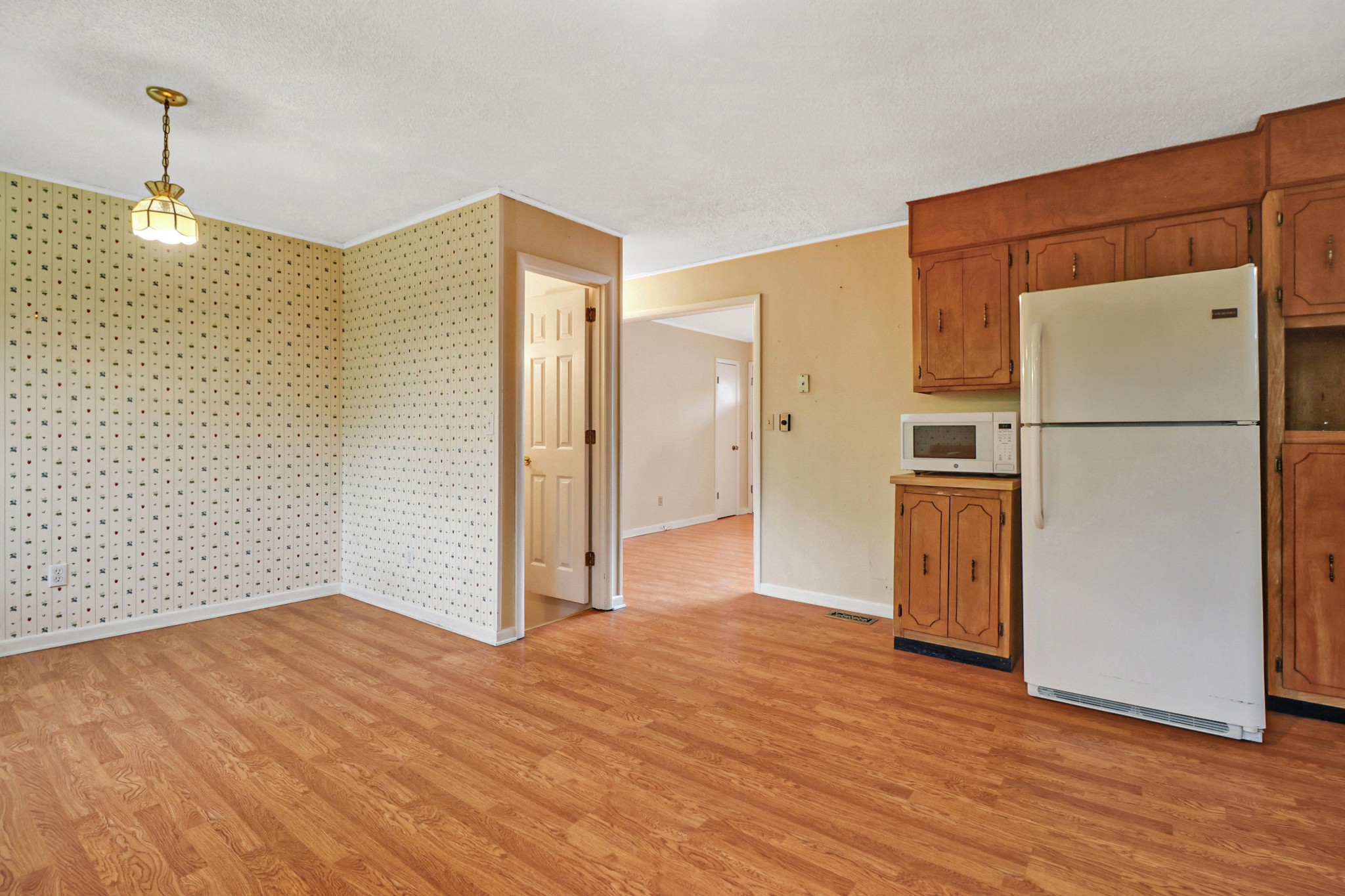 148 Porter Lane Spring City, TN 37381 - Photo 32 of 53 a view of a refrigerator in kitchen and wooden floor