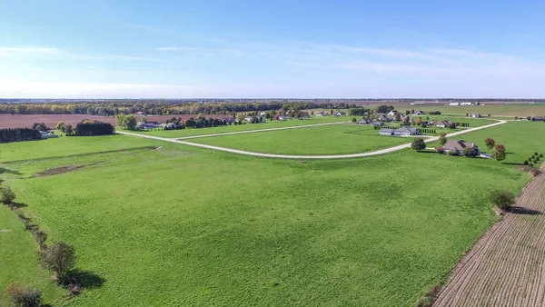 an aerial view of a golf course with a big yard