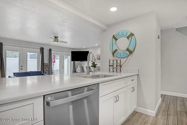 a kitchen with stainless steel appliances granite countertop a sink and a wooden floors