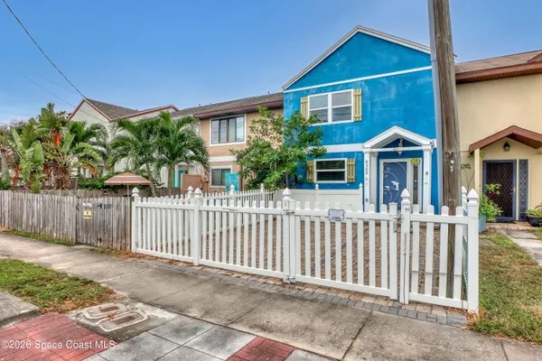 a front view of a house with wooden fence