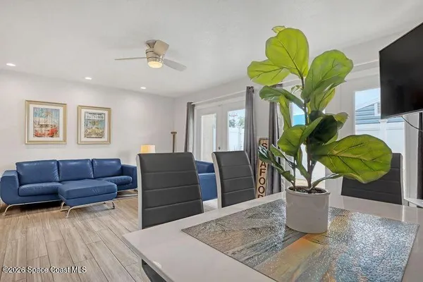 a view of living room with furniture and a potted plant