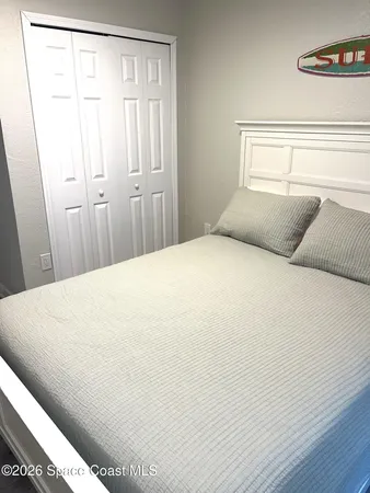 a large white bed in a small room