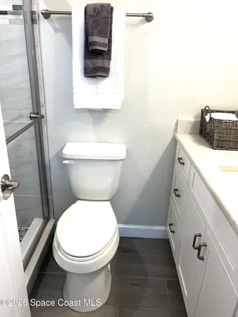 a white toilet sitting next to a bathroom sink