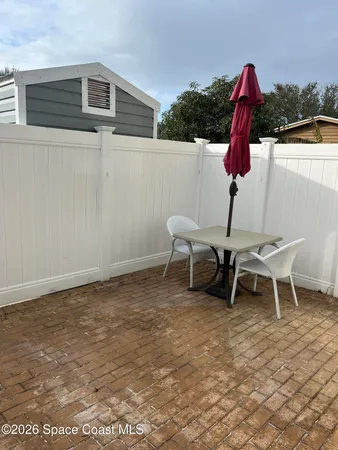a backyard of a house with table and chairs