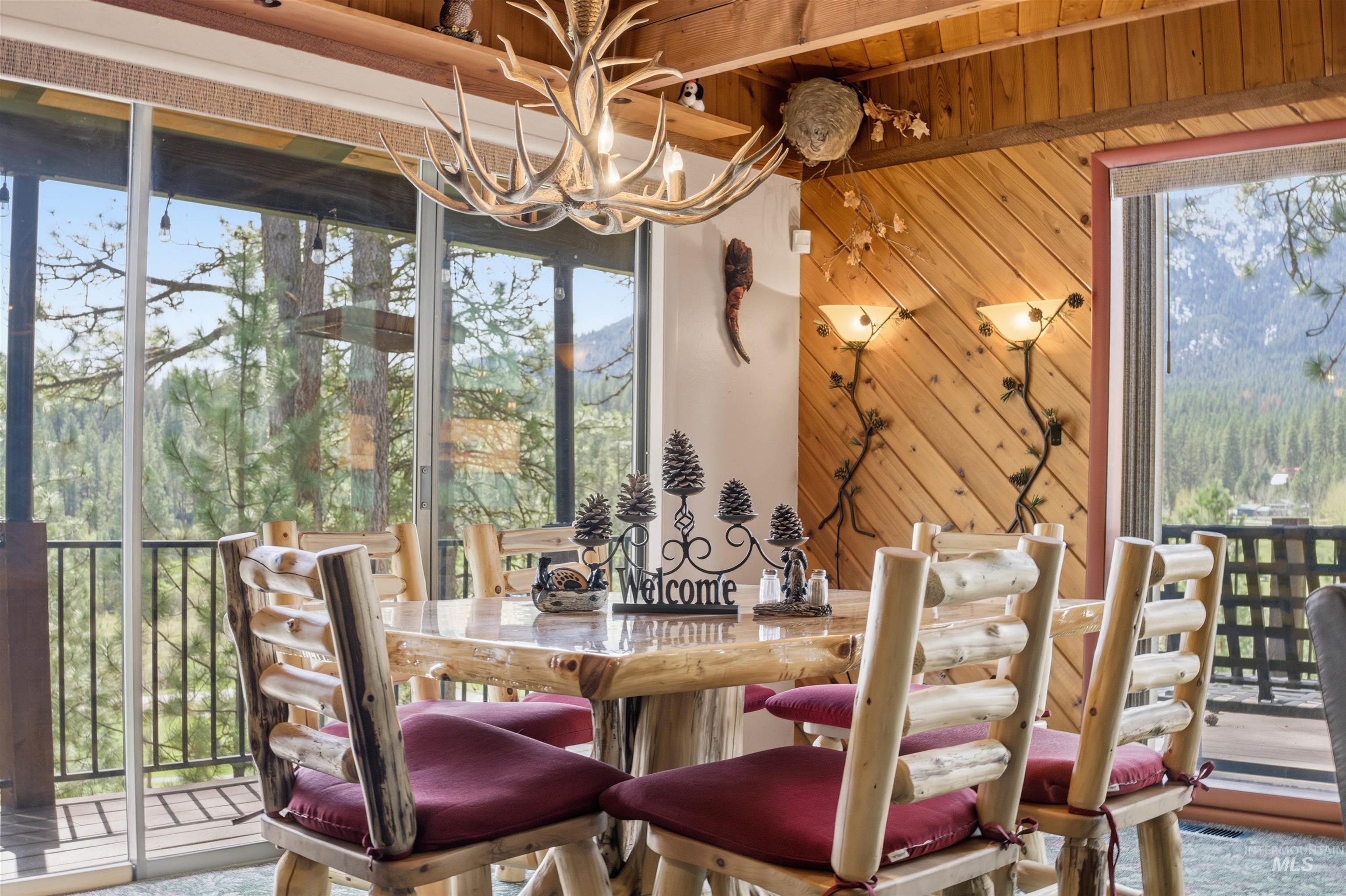 45 Rainbow Ridge Road Garden Valley, ID 83622 - Photo 11 of 41 Dining room with a chandelier and wood walls