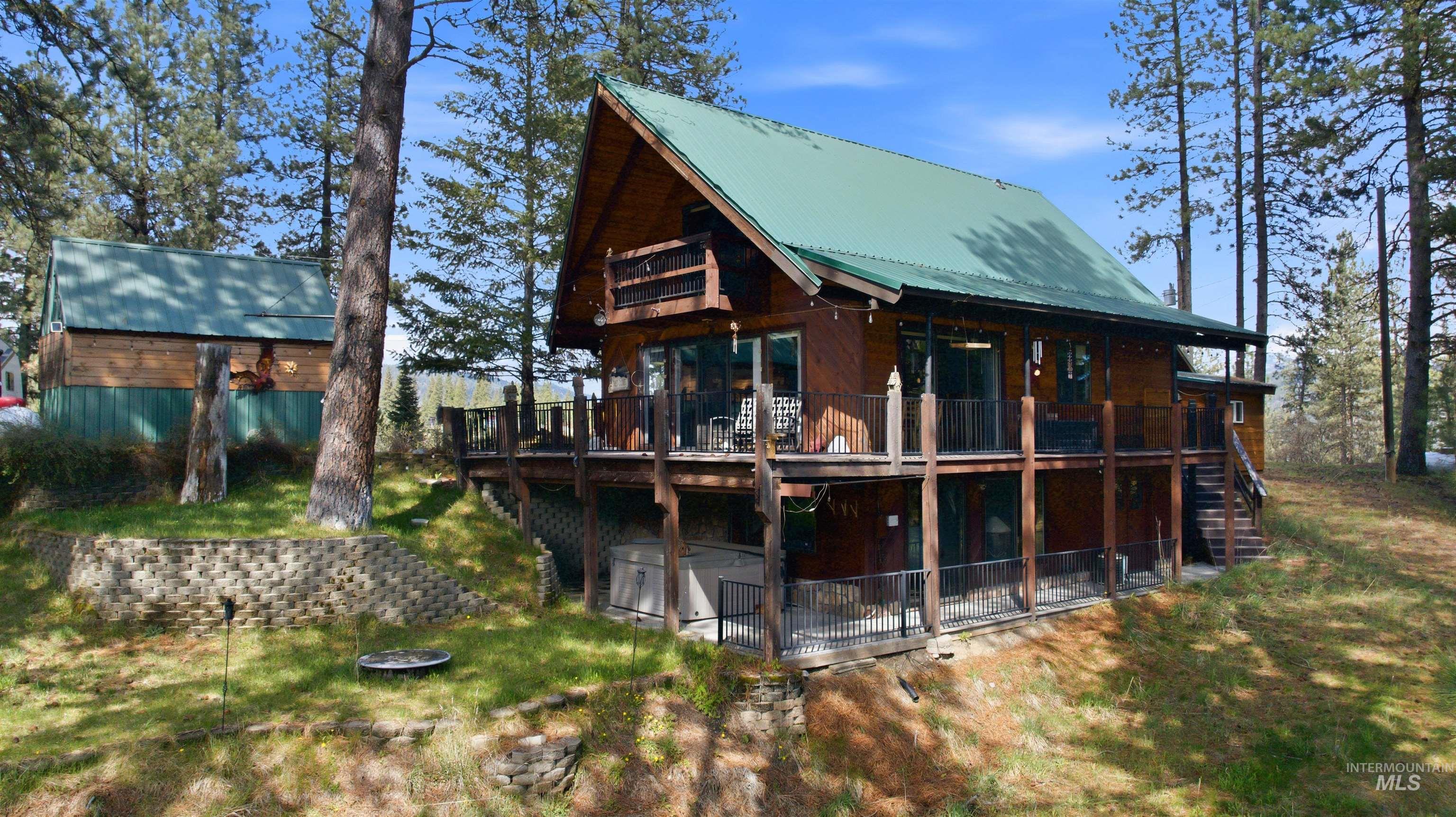 45 Rainbow Ridge Road Garden Valley, ID 83622 - Photo 2 of 41 Back of house with a wooden deck and a metal roof