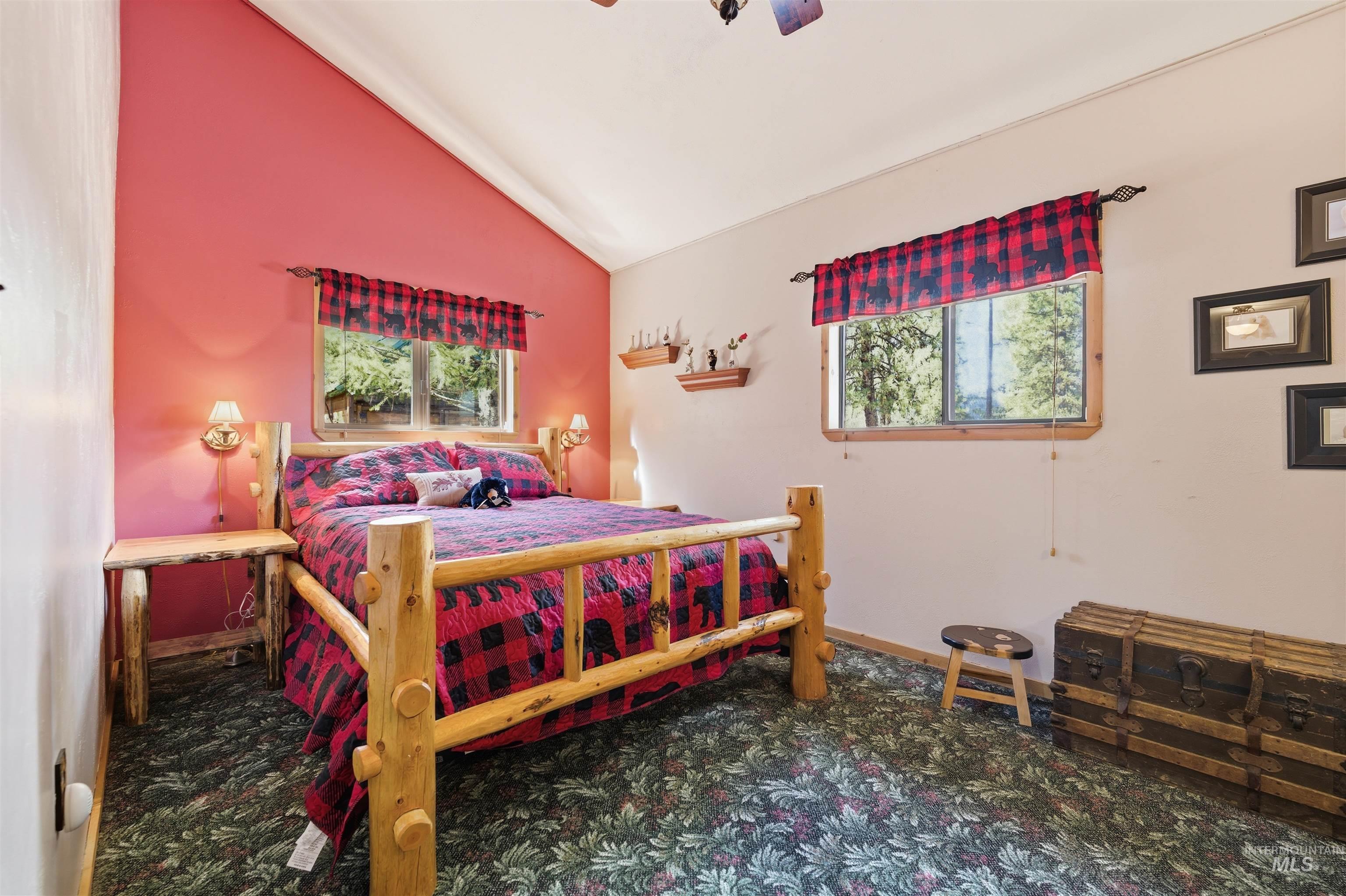 45 Rainbow Ridge Road Garden Valley, ID 83622 - Photo 22 of 41 Bedroom featuring lofted ceiling, multiple windows, dark colored carpet, and ceiling fan