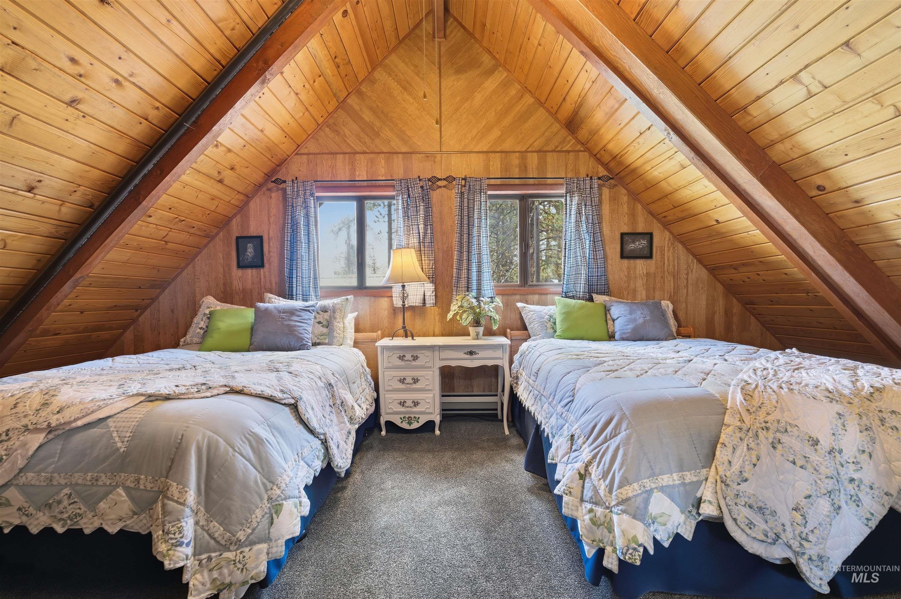 45 Rainbow Ridge Road Garden Valley, ID 83622 - Photo 30 of 41 Carpeted bedroom featuring a wooden ceiling with exposed beams and baseboard heating