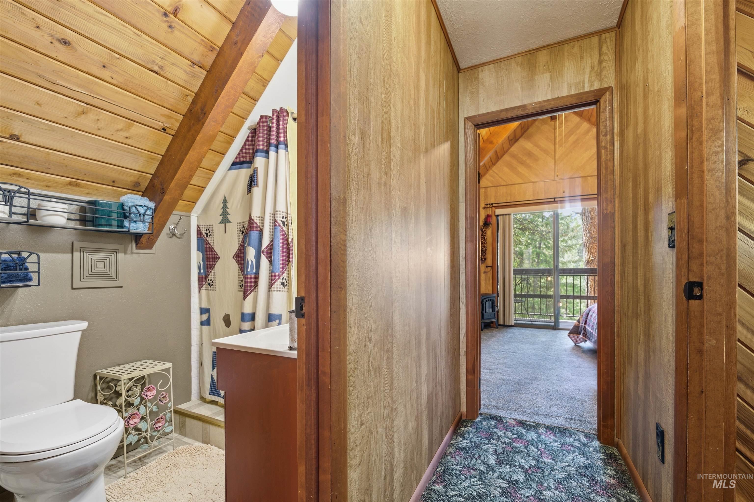 45 Rainbow Ridge Road Garden Valley, ID 83622 - Photo 33 of 41 Full bathroom with a shower stall, carpet flooring, lofted ceiling with beams, and wood ceiling