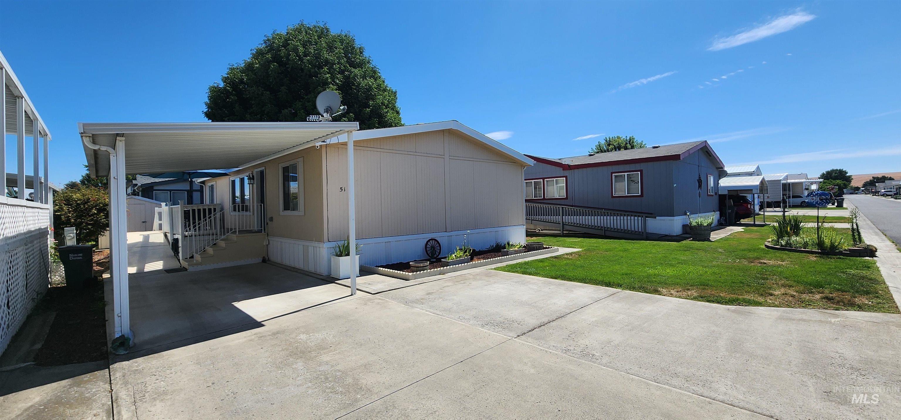 2115 6th Avenue, Unit 51 Clarkston, WA 99403 - Photo 1 of 45 Front side view of house featuring a yard and concrete driveway