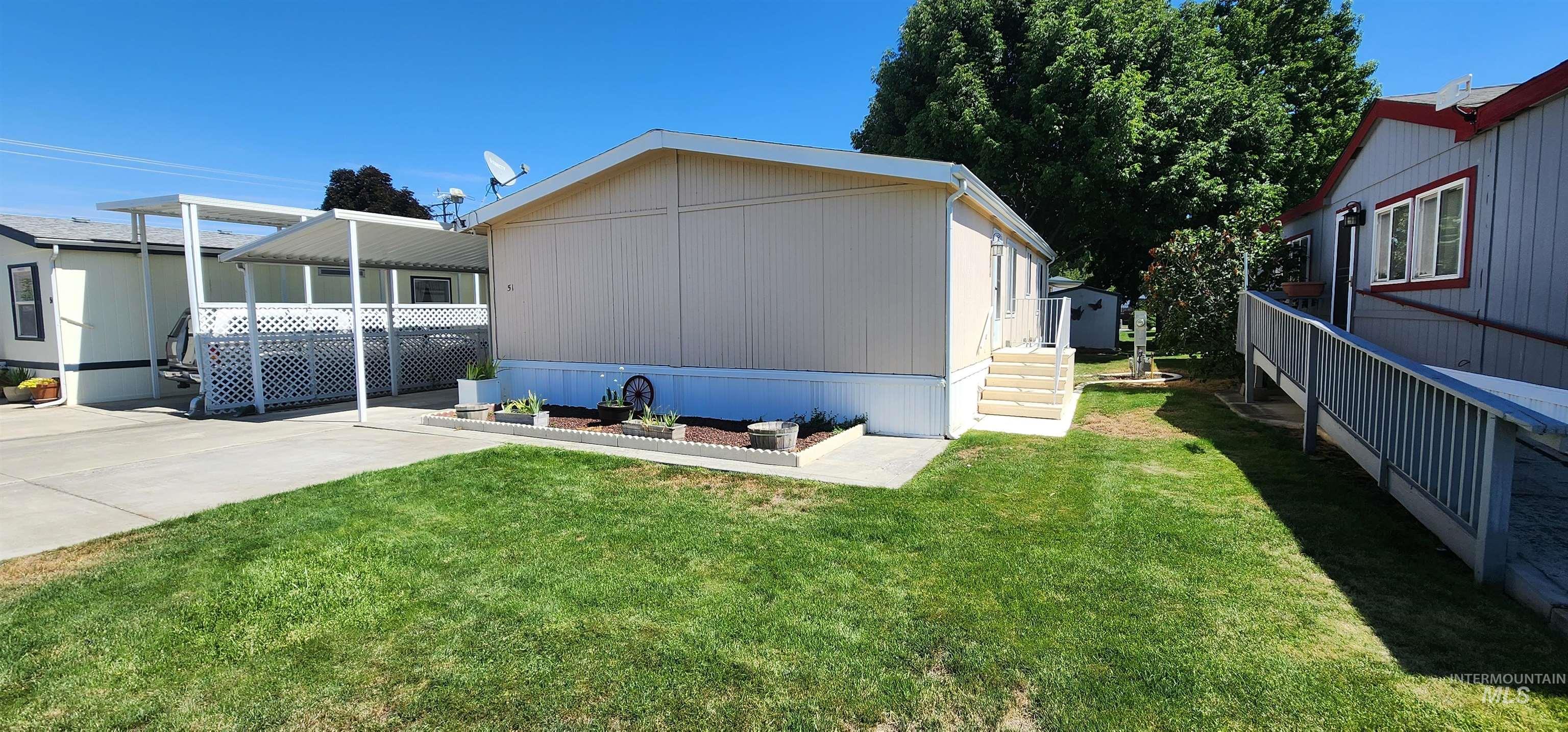 2115 6th Avenue, Unit 51 Clarkston, WA 99403 - Photo 32 of 45 Back of property with a yard, a carport, and concrete driveway