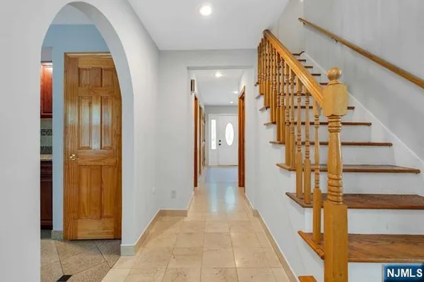 a view of entryway and hall with wooden floor