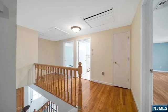 a view of hallway with wooden floor