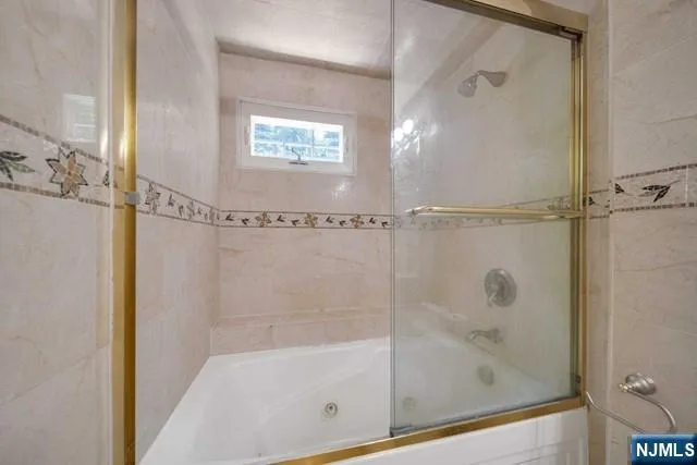 a bathroom with a glass shower door