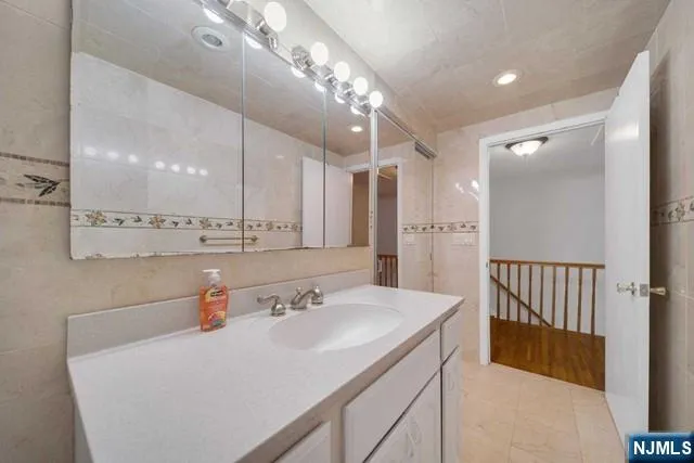 a bathroom with a sink a large mirror and shower
