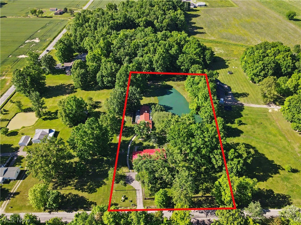 4250 Herr Fieldhouse Road Southington, OH 44470 - Photo 50 of 50 Aerial perspective showcasing a property surrounded by mature trees, featuring a private pond